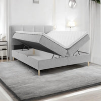 Lit BOXSPRING LEO - Avec tête de lit, coffre intégré, matelas ressorts ensachés et surmatelas inclus
